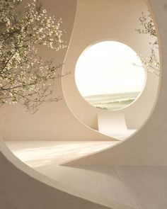 a white building with a round window in the center and flowers growing out of it