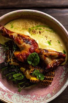 a bowl filled with food on top of a wooden table