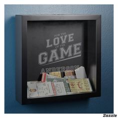 a black frame with some tickets in it and the words love game written on it