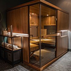 an indoor sauna with wooden walls and glass doors