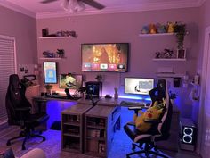 a room with two computer monitors and a desk