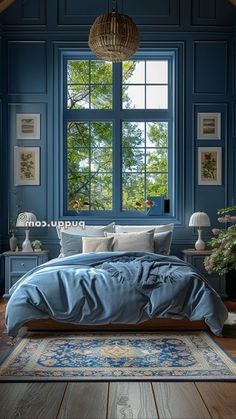 a bedroom with blue walls and wooden flooring has a large bed in front of the window