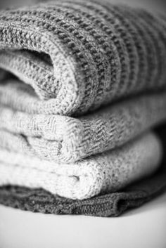 stack of folded sweaters in black and white