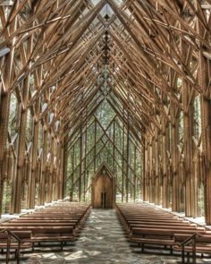 the inside of a wooden church with rows of pews