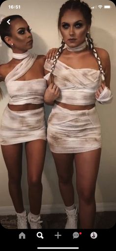 two women dressed in white posing for the camera with their hands on their hipss