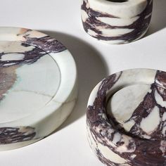 two marbled dishes sitting next to each other on a table