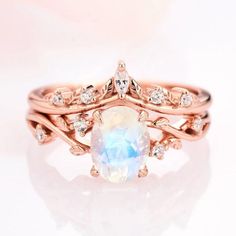 a close up view of a ring with an opal stone in the center and diamonds around it