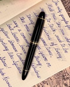 a fountain pen sitting on top of a piece of paper that has writing on it