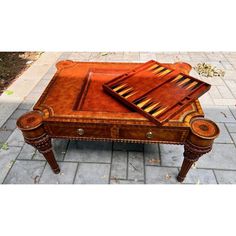 a wooden table with two drawers on it and an open drawer in the middle that has several pieces of wood sticking out of it