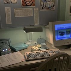 an old computer sitting on top of a desk next to a keyboard and mouse,