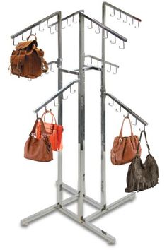 four purses are hanging on a rack with multiple hooks and two bags in them