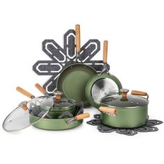 an assortment of green pots and pans with wooden handles