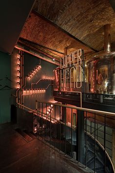 the stairs are lit up with red lights in an old building that has been converted into a bar