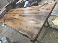 a large wooden table sitting on top of a metal frame in a room filled with furniture