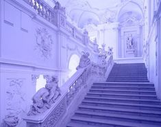 an ornate staircase with statues on either side