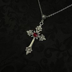 "This richly detailed antiqued silver tone cross is accented with a Dark Ruby sparkling glass crystal. Pendant is 1 5/8\" wide and 3 1/4\" tall in (from bail to bottom point).  Pendant comes with a soldered stainless steel cable chain in your choice of length. It closes with a lobster clasp and chain extender so you can adjust the length as needed. If you would like a different length, please send us a message. Matching cross earrings are listed separately in our store. If you would like this design in a different stone color, feel free to ask about availability." Raw Carnelian, Pinterest Shop, Victorian Vampire, Jewelry Minimal, 2023 Outfits, Y2k Accessories, Vampire Goth, Goth Necklace, Carnelian Necklace