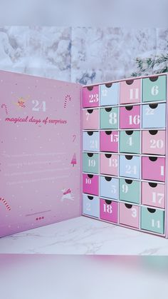 a pink and blue calendar sitting on top of a table