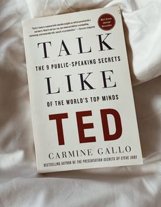 the book talk like ted is laying on top of a white bed sheet and it's cover