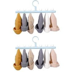 four pairs of socks hanging on a clothes hanger with two clips attached to them