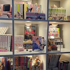 the shelves are filled with many books and toys, including one for children's bookcases