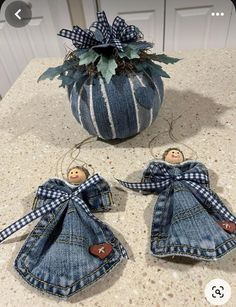 two denim angel ornaments sitting on top of a counter