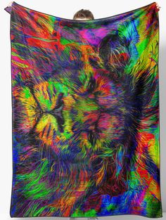 a multicolored image of a cat's face on a colorful wall hanging tapestry