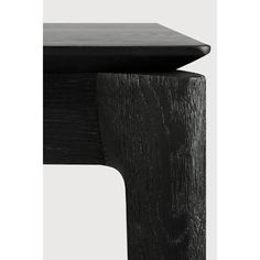 a close up of a black table with wood grained edges and an angled edge