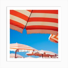 many umbrellas are lined up against the blue sky