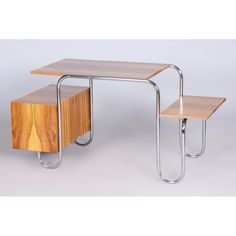 two wooden tables sitting next to each other on top of a white floor with metal legs