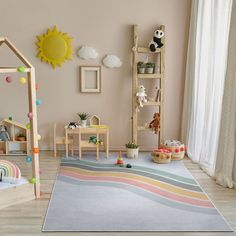 a child's playroom with toys and decor in pastel pinks, yellows, and greens