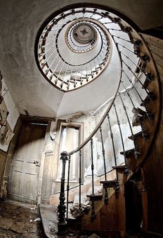 a spiral staircase in an abandoned building