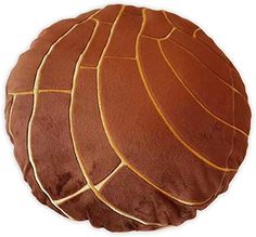 a brown round cushion with gold lines on it