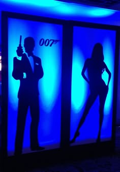 the silhouettes of two women and a man are shown in front of blue lights