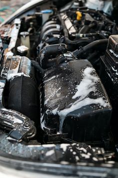 the engine compartment of a car covered in snow