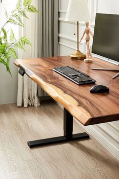 a wooden desk with a computer on it and a lamp in the corner next to it