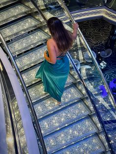 a woman walking down an escalator in a dress