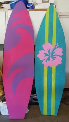 two surfboards sitting next to each other in a room