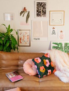 a living room filled with lots of furniture and pictures on the wall above it's couch