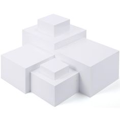 three white boxes stacked on top of each other in the shape of an abstract structure