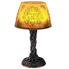 a lamp that is sitting on top of a table with a yellow shade over it