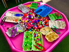 a pink table topped with lots of plastic toys