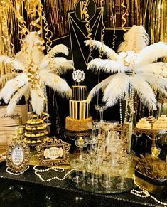 a table topped with lots of desserts and cakes covered in white feathered decorations