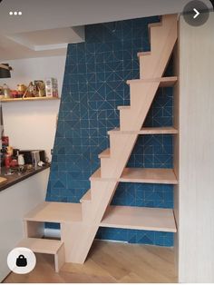 the stairs are made out of wood and have blue tiles on them, as well as shelves