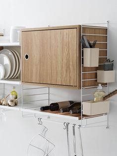 a kitchen shelf with dishes and utensils on it