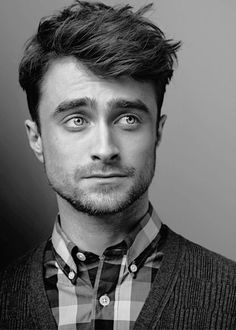 a black and white photo of a man with blue eyes wearing a bow tie looking at the camera