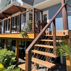 a house with a deck and stairs leading up to the front door