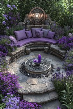 an outdoor seating area surrounded by purple flowers and greenery, with a circular stone fire pit in the center