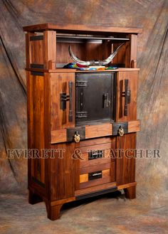 a wooden cabinet with two doors and drawers on the bottom, one door open to reveal an image of a bull's skull