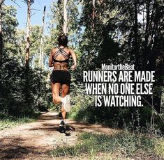 a woman running down a trail in the woods with a motivational quote above her