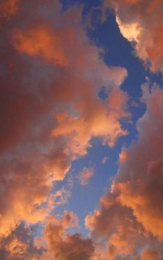 an airplane is flying in the sky at sunset or dawn with pink clouds and blue skies